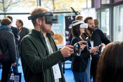 A man trying a VR headset in a large room